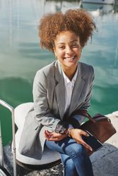 Black woman in smart casual outfit in port