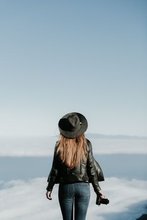 Woman with camera enjoying cloudscape
