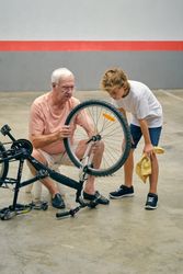 Boy with grandfather repairing bicycle