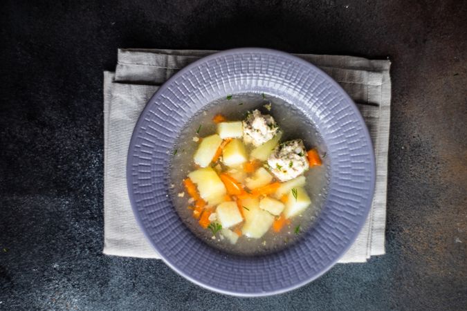 Healthy soup with potato and carrot and meat balls served on the table with copy space