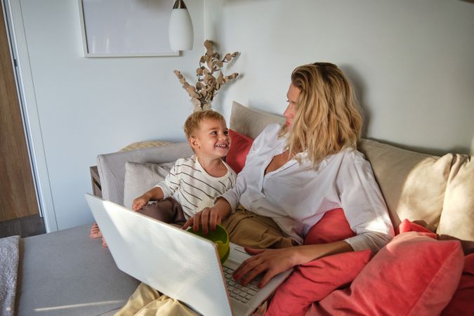 Mother and son having fun while watching movie on netbook