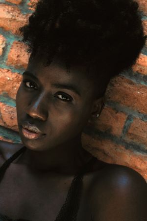 Black woman leaning against wall