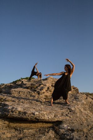 Women dancing near stones
