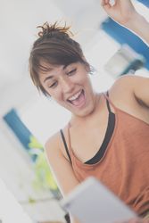 Joyful woman reading something on phone