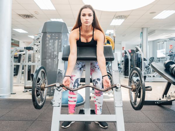 Young woman lifting barbell