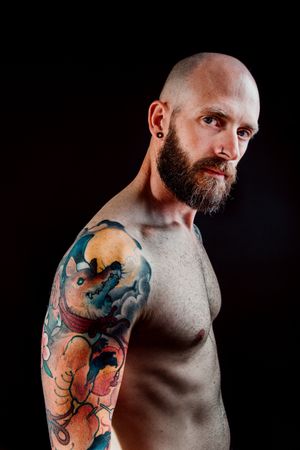 Young shirtless bearded guy with tattoos