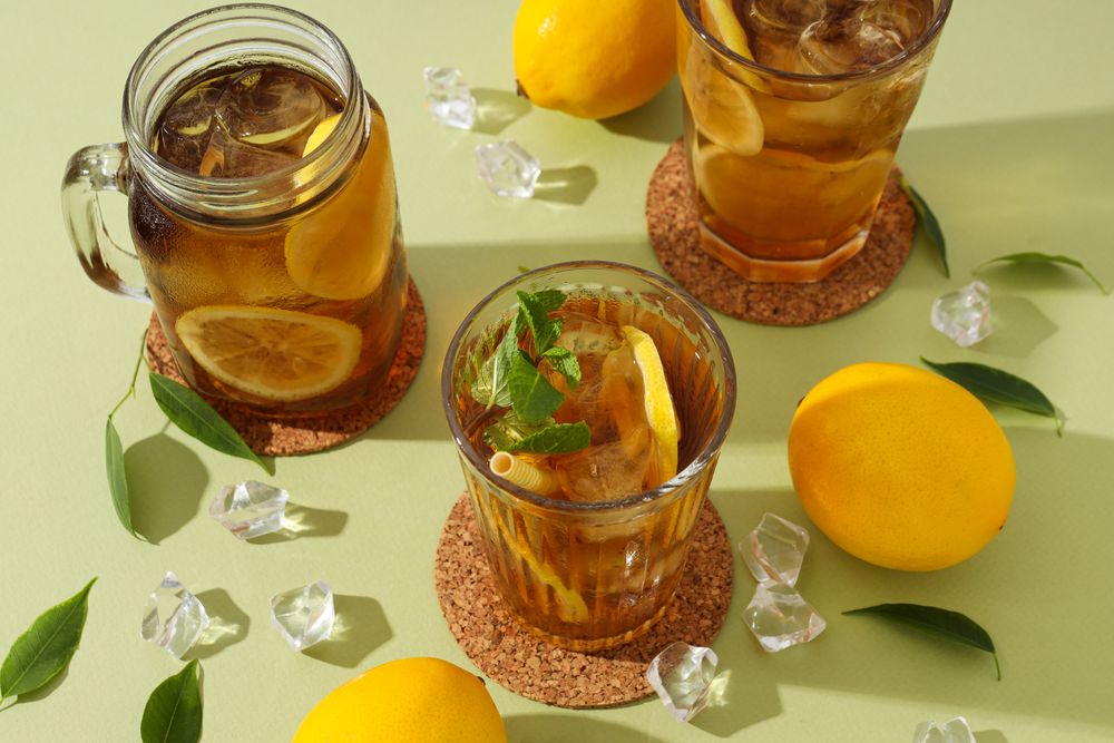 Cold tea with ice, mint leaves and orange slices