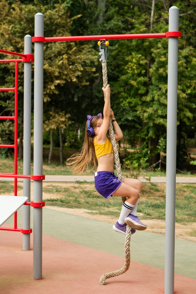Girl climbing on sports ground