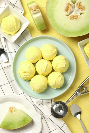 Ice cream scoops in a bowl with slices of fresh melon