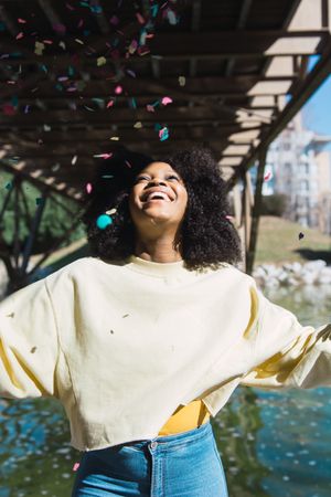 Woman throwing confetti in the air.