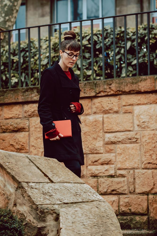 Young woman with book on steps