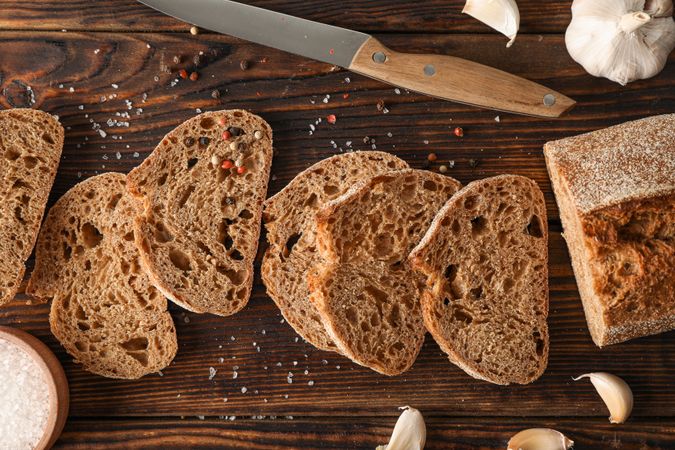 Flat lay composition with freshly baked bread on wooden background, top view