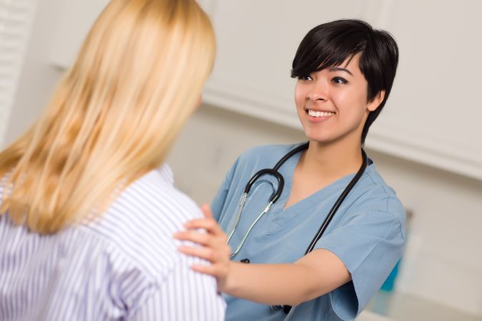 Young Female Doctor Talking with Patient