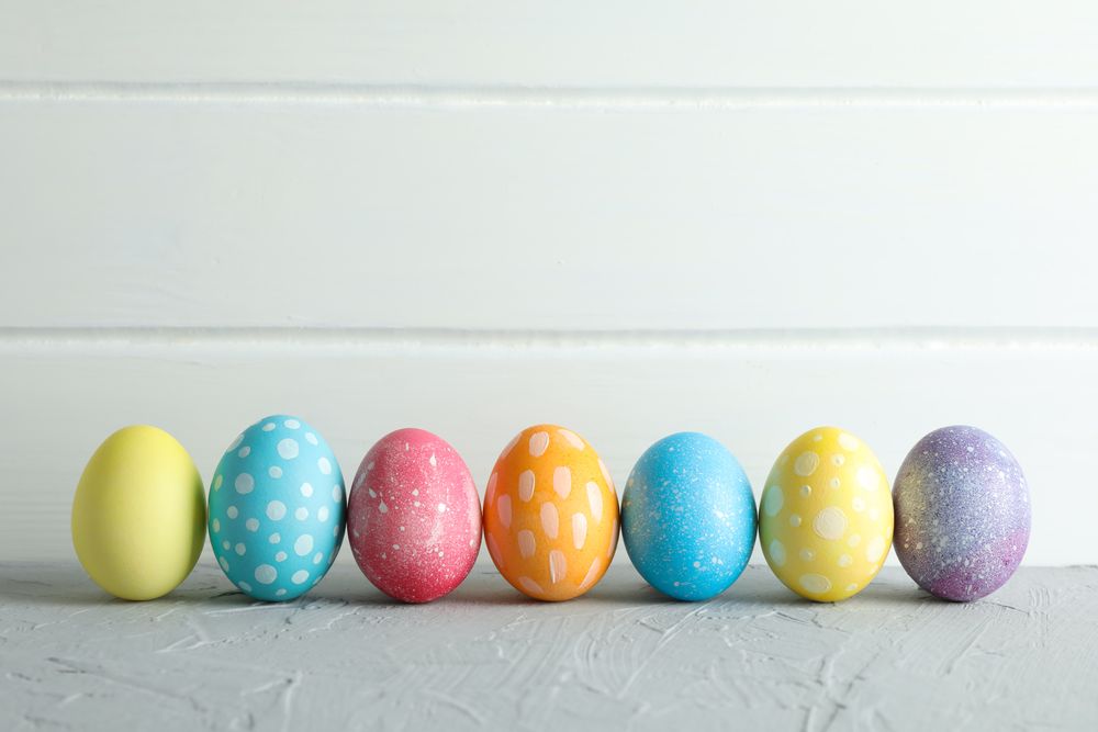 Decorated Easter eggs on color background, closeup. Space for text