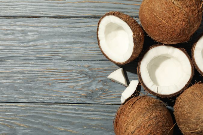 Coconut on wooden background, top view. Tropical fruit