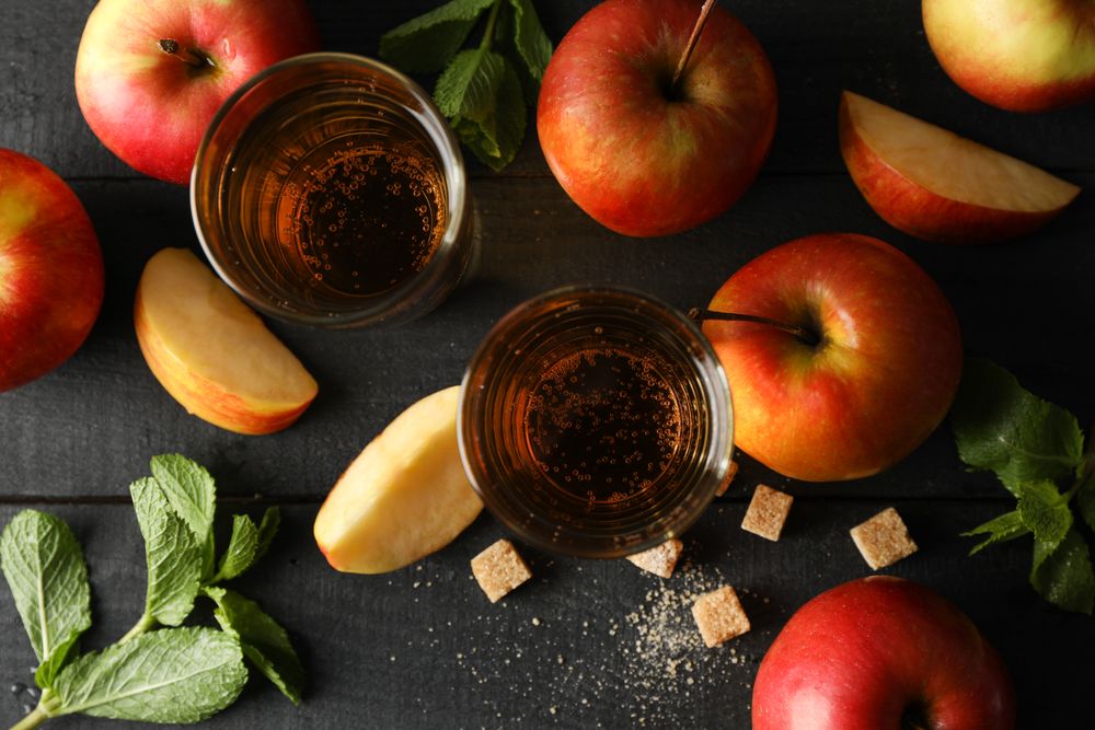 Composition with cider, sugar and apples on wooden background