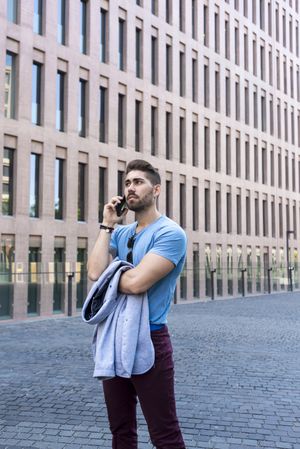 Young man talking on his phone outdoors