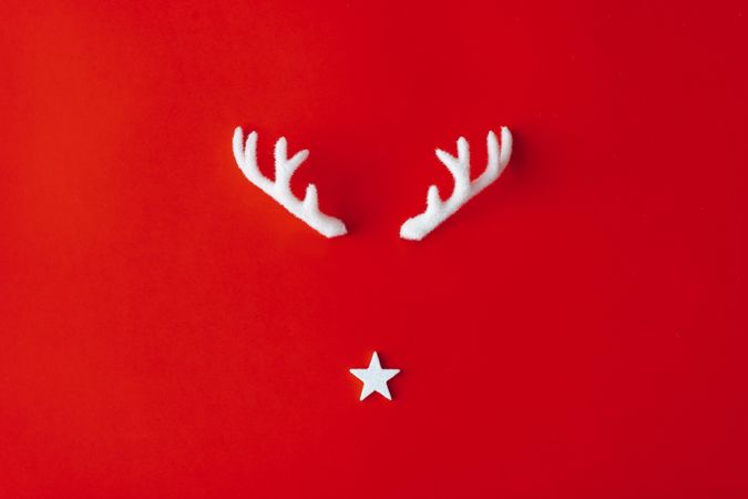 Reindeer antlers with star on red background