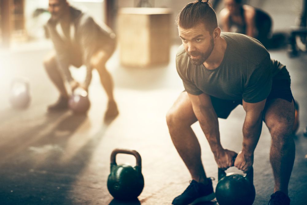 Man exercising with kettlebell in gym