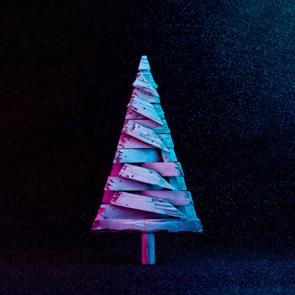 Christmas tree in vivid neon colors on dark  background