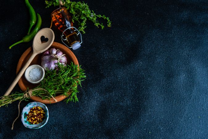 Cooking concept with oregano, chili and garlic on counter with copy space