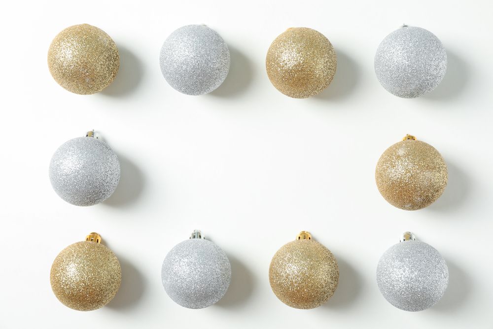 Flat lay with christmas balls on plain background, space for text