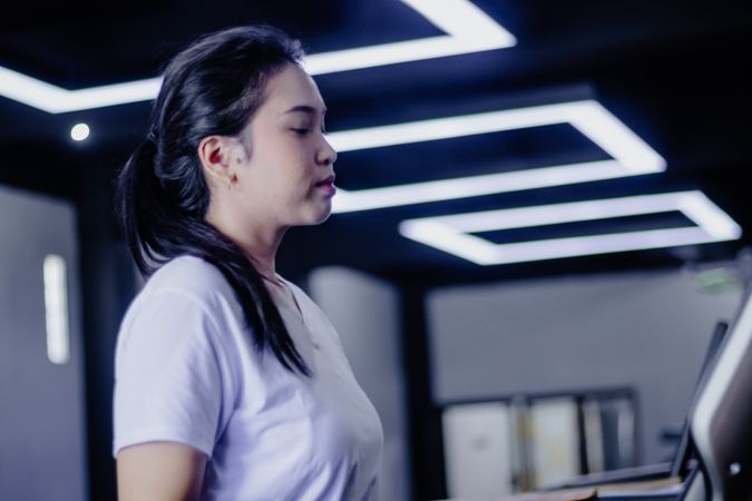 Focused Woman on Treadmill: Mindful Fitness and Inner Strength