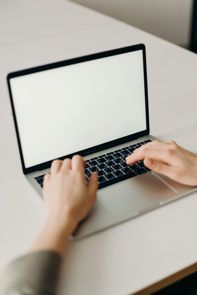 Person using laptop on light table