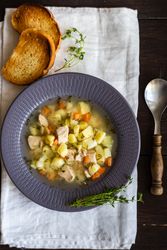 Top view of healthy soup with potato and carrot and meat balls served with toast on the table with copy space
