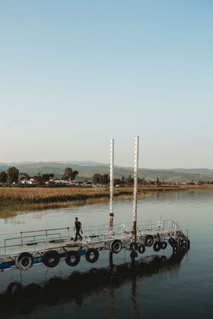 Tourist walking on shabby pier