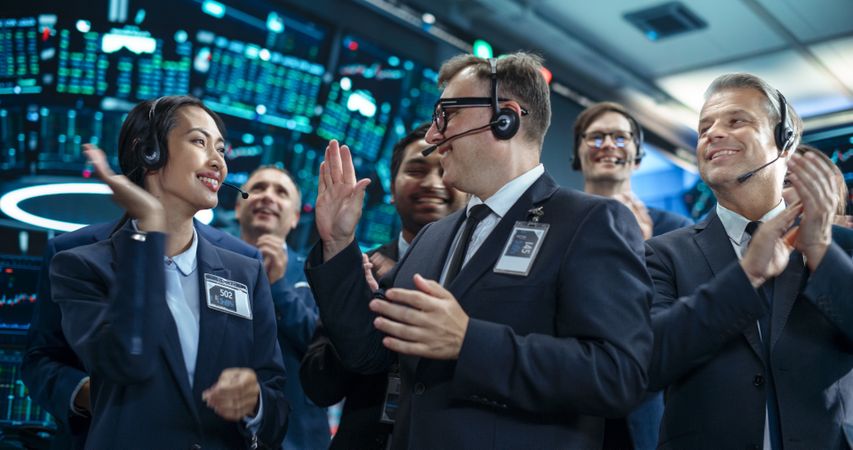 Team of Happy Investment Bankers Applauding, Celebrating and Congratulating Each Other on a Profitable Trading Day.