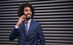 man taking phone near wall