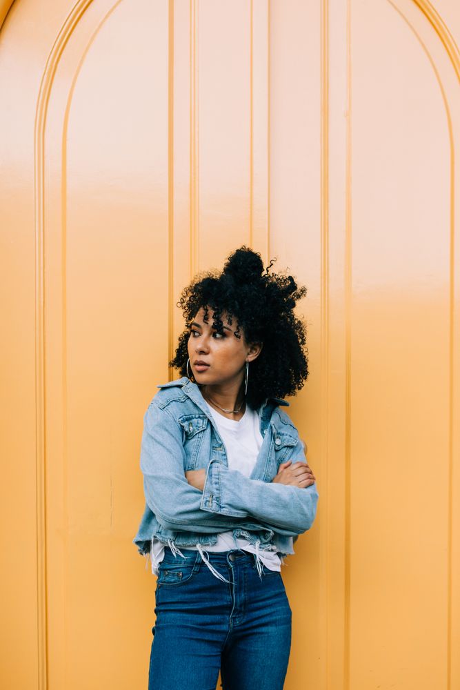 Stylish female by yellow door