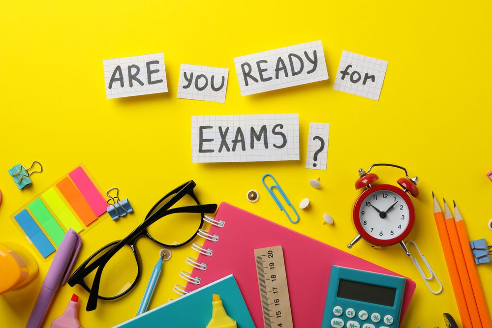 Flat lay of “are you ready for exams” with stationary on yellow table