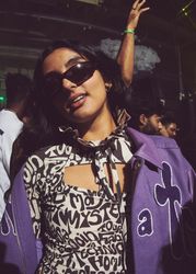 London, England, United Kingdom - Nov 9, 2022: Female in purple shirt and sunglasses in club