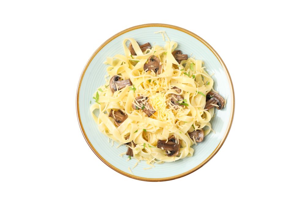 Plate with pasta, cheese and mushrooms isolated on plain background
