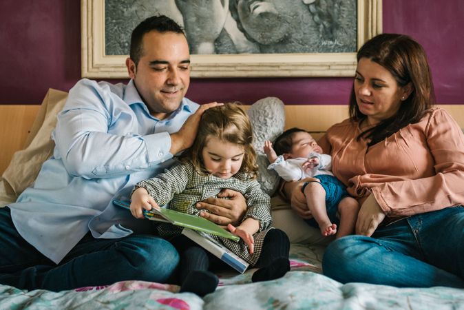 Happy family having fun in bedroom
