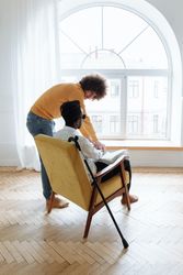 Back view of young man teaching braille system to a visually impaired man
