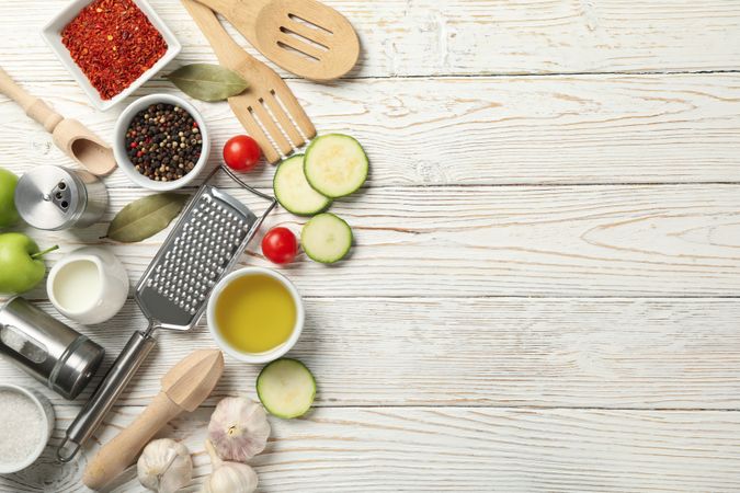 Composition with kitchen cutlery and ingredients for cooking on wooden background, top view