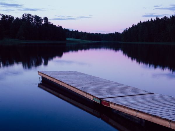 Wooden planked footway in calm evening lake