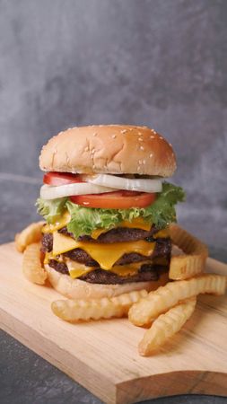 Gourmet Cheeseburger and Fries on Cutting Board