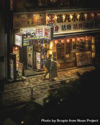 Top view of man and woman walking on sidewalk at night in Japan 0LWnyb