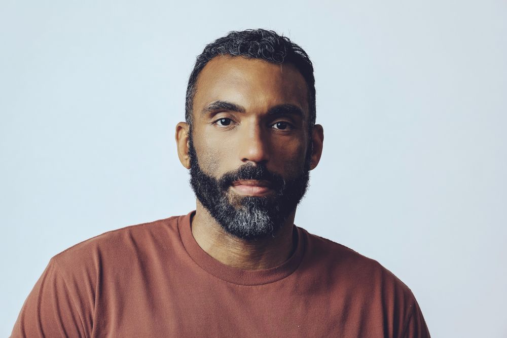 Head shot of serious Black male in grey studio