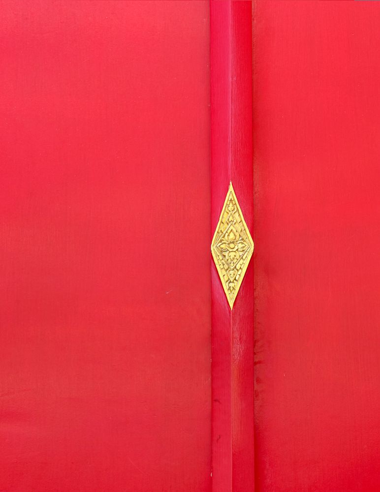 Asian golden detail is  on red wooden background. Thai golden ornament.