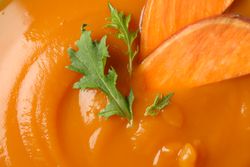 Top view close up of sweet potato soup with garnish