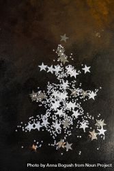 Christmas card concept of star confetti on table in shape of Christmas tree 5z3Yj4