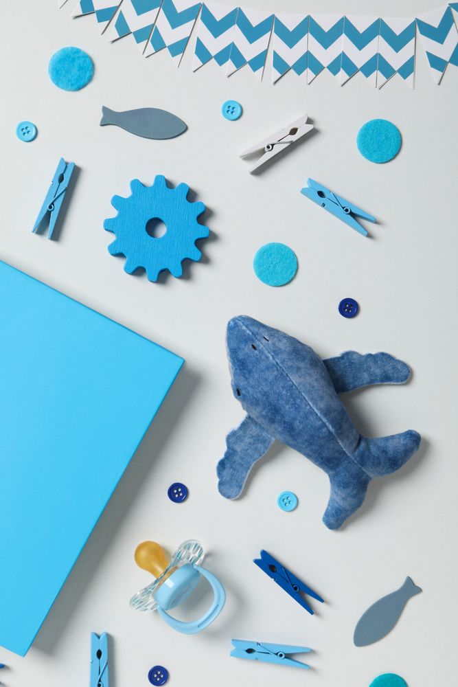 Blue children's book, with toys, on a light background.