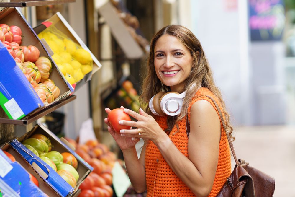 Woman shopping fresh fruits and vegetables at organic food market