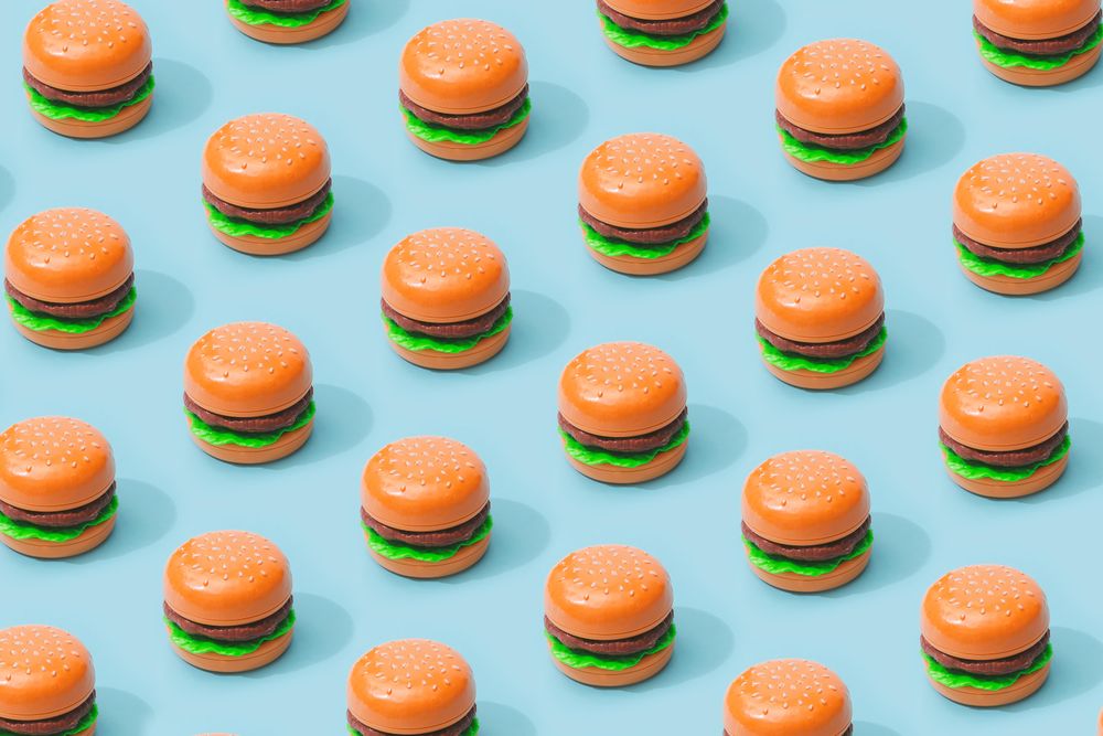 Hamburger fast food pattern on pastel blue background