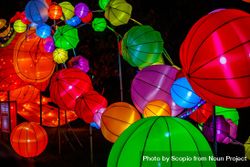 Colorful lit paper lanterns at night bGXAY0